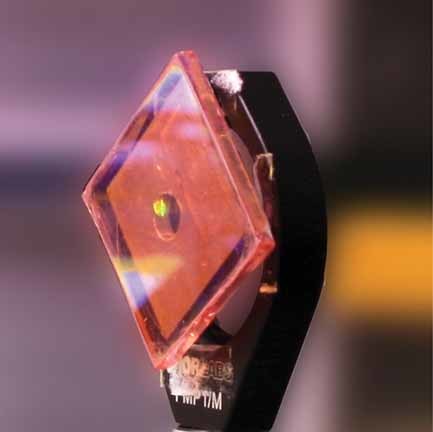 Nanoparticle One-Dimensional Photonic-Crystal Dye Laser